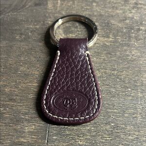 Dooney &‎ Bourke leather key fob, featuring an embossed logo dark plum